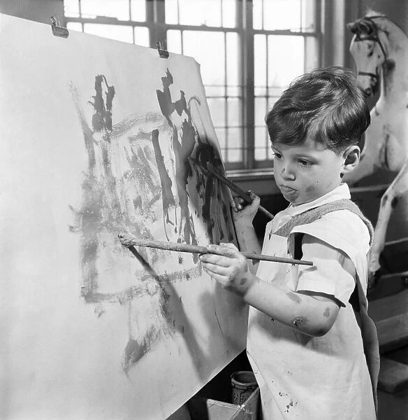 The four year old two handed artist is Louis Savva at work on his 'masterpiece'