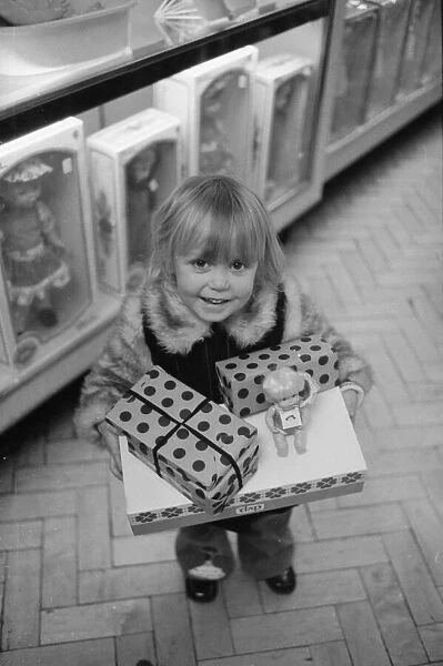 Three year old Mandie Keating of Boreham Wood with her arms full of parcels doing some
