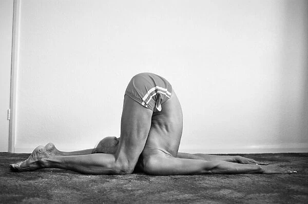 Yoga positions. Position is called The Deaf Man Pose (Karnapidasana
