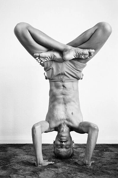 Yoga positions. Position is called Lotus in Tripod Headstand