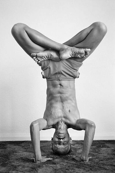 Yoga positions. Position is called Lotus in Tripod Headstand