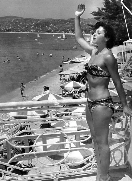 Yolande Blatt waves a friend from the Casino Terrace during her holidays July 1949