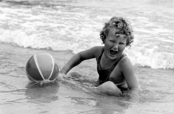 Framed Print : Yound girl playing with her beach ball during a holiday at the seaside Circa 1945