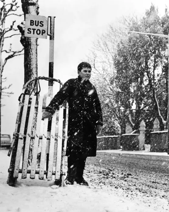 Framed Print : Young Andrew Burley stands in the queue for the bus with his sledge during heavy snowfall Framed Print : Young Andrew Burley stands in the queue for the bus with his sledge during heavy snowfall