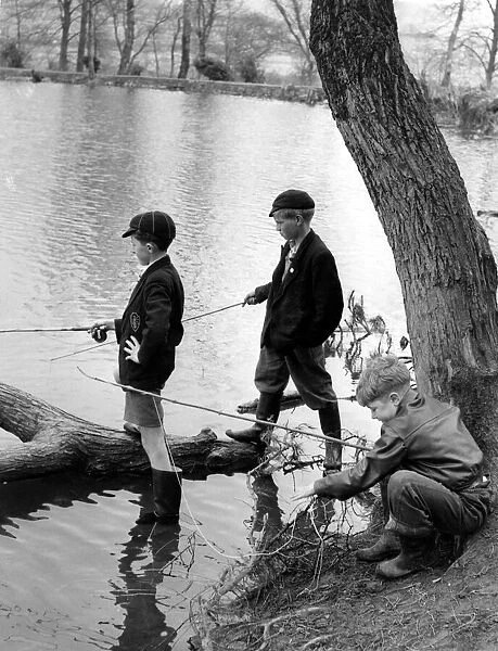 Three young anglers make for a picturesque picture as they fish at the Top Ponds
