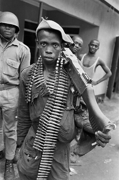 A young Biafran soldier seen here posing with a heavy machine gun