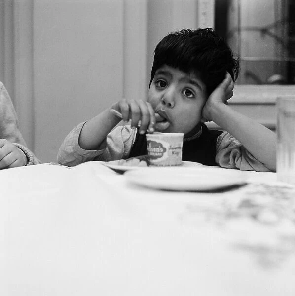 A young boy eating ice-cream. 1957