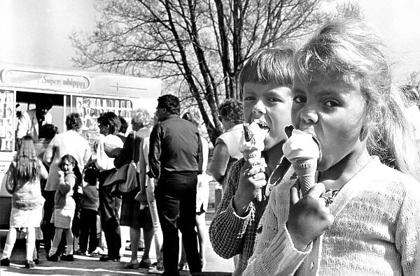 A young boy and girl enjoy their ice creams at Wyken Slough pool, Coventry