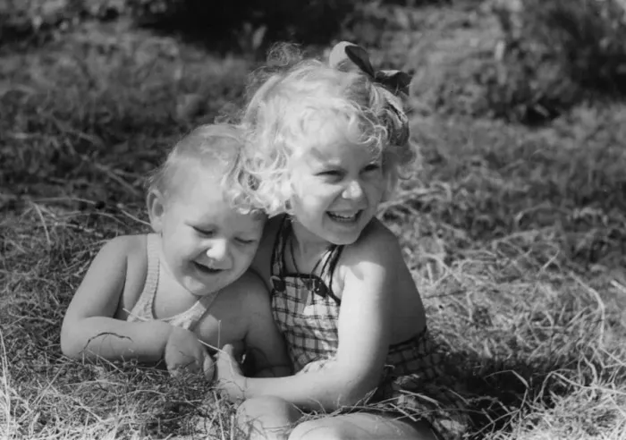 Framed Print : Young boy and girl playing in the grass Circa 1945 P044463