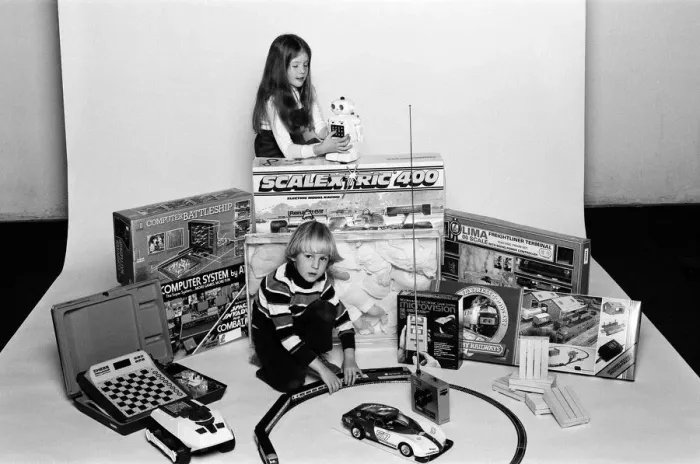 Framed Print : A young boy and girl with a selection of childrens toys for Christmas. December 1980