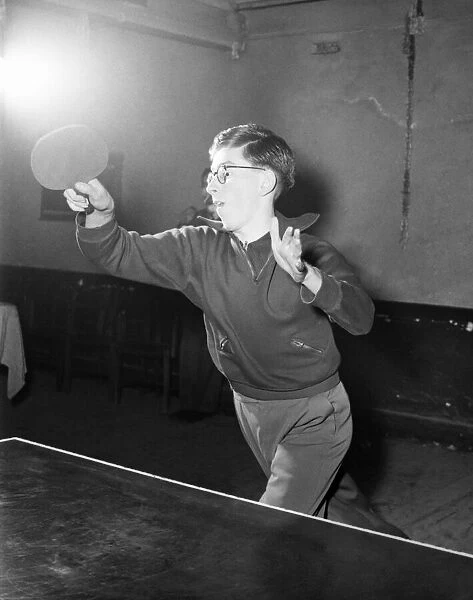 Young boy playing table tennis. January 1953 D232-003