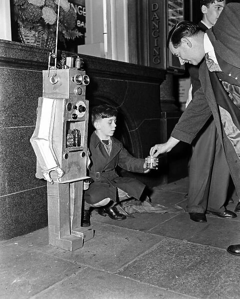 A young boy with a robot guy. 8th October 1957