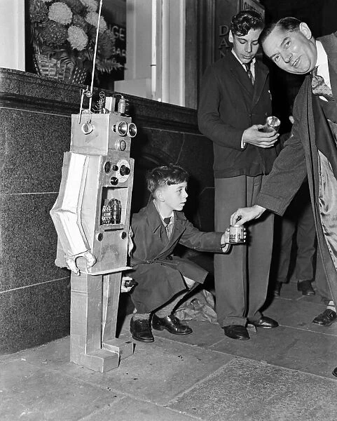 A young boy with a robot guy. 8th October 1957