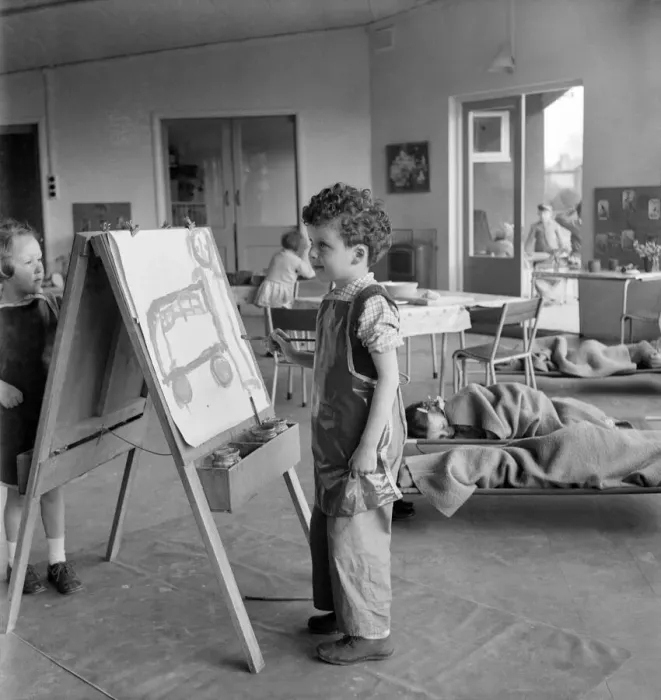 Framed Print : Young boy standing by his easel during an art class at Cookham Nursery School Framed Print : Young boy standing by his easel during an art class at Cookham Nursery School