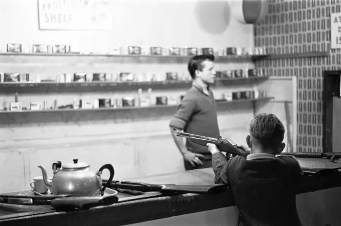 Framed Print : A young boy tries his luck on the rifle range stall at the end of Southend pier Framed Print : A young boy tries his luck on the rifle range stall at the end of Southend pier