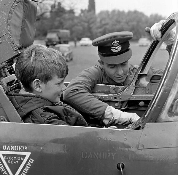 A young boy (unidentified) enjoys sitting in the cockpit of a plane