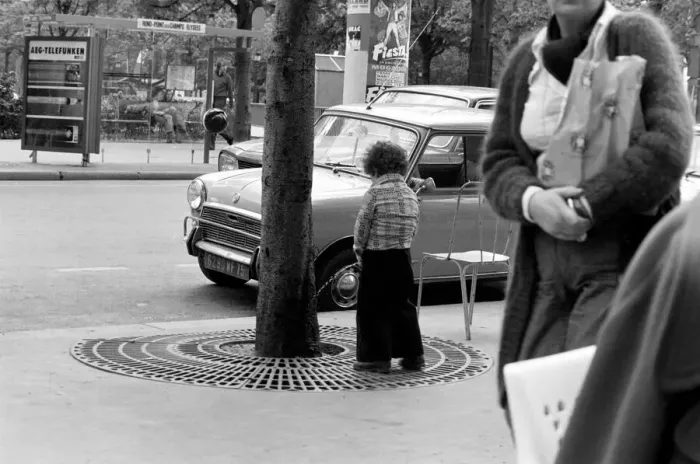 Framed Print : Young boy urinates outside a cafe on the Champs Elysees in Paris, France Framed Print : Young boy urinates outside a cafe on the Champs Elysees in Paris, France