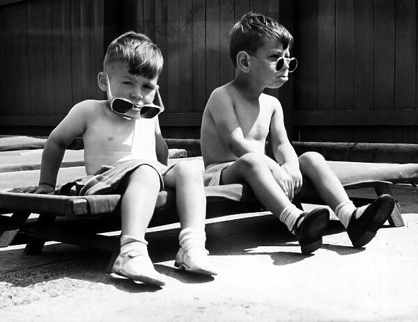 Two young boys from Bridge St nursery, Newcastle, do a bit of sunbathing August