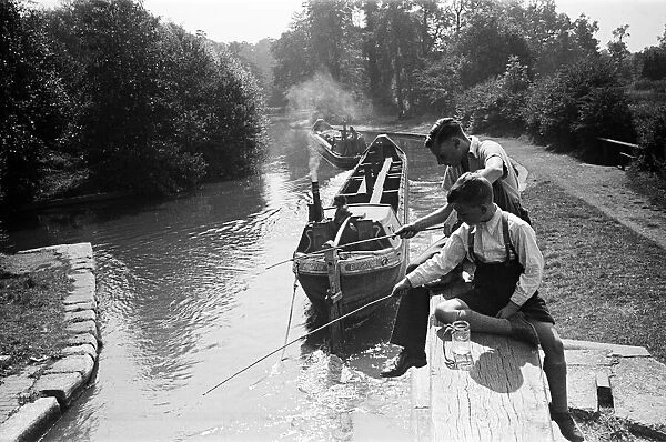 Young boys fishing on a canal near Watford, Hertfordshire. Circa 1945