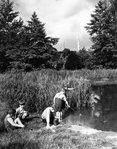 Young boys fishing in the River Gade at Hemel Hempstead in Hertfordshire