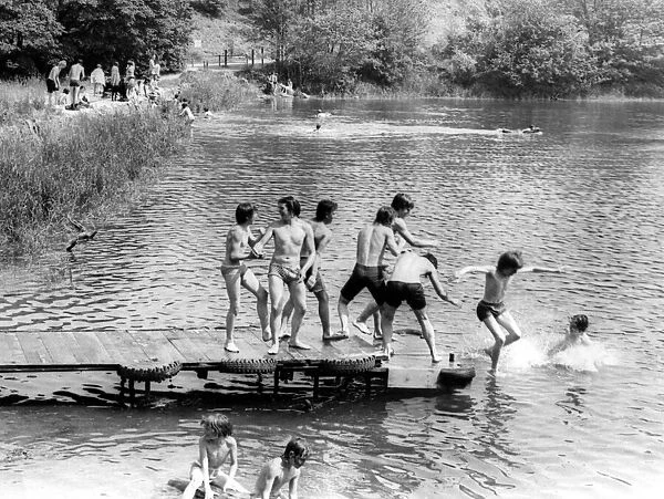 Young boys playing in the water on a hot day at Oldbury Reservoir near Atherstone
