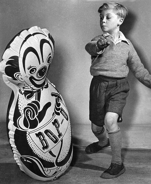 Young child with a large inflated balloon, bought from the seaside Circa 1955