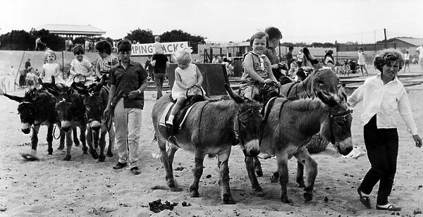 Young children enjoying donkey rides on the beach. 6th August 1968