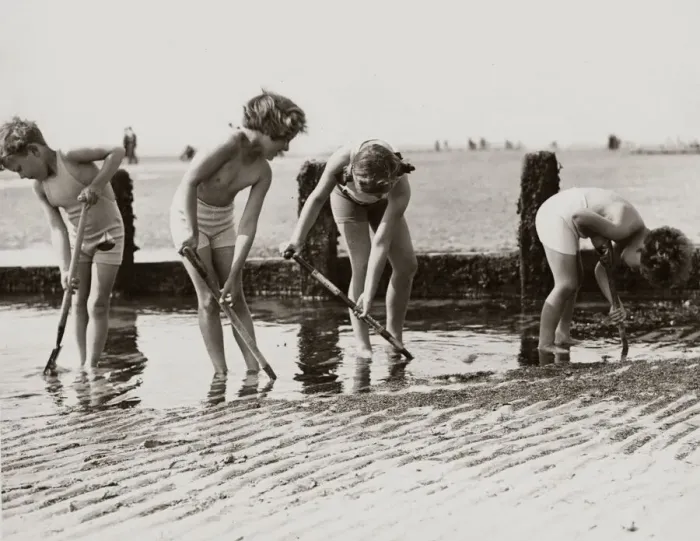 Framed Print : Young children looking for crabs and other beach life hiding in the sands on the beach Framed Print : Young children looking for crabs and other beach life hiding in the sands on the beach