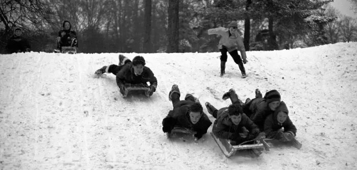 Framed Print : Young children make the most of the cold weather by going sledging at The Grove Framed Print : Young children make the most of the cold weather by going sledging at The Grove