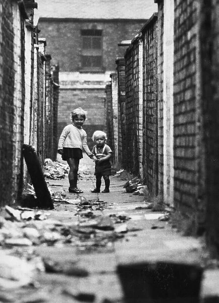 Young children play in the back alleyways behind Clifton Street in Ordsall, Salford