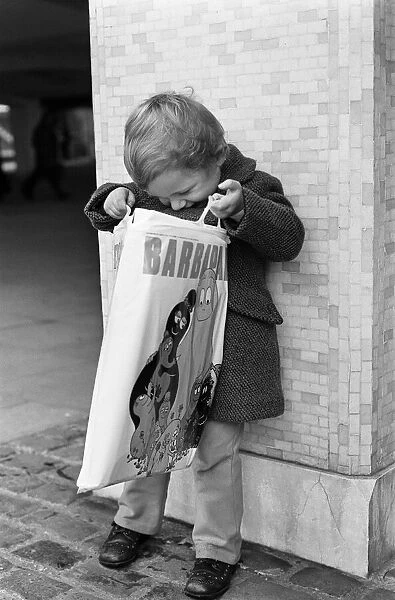 A Young Christmas shopper in Birmingham, West Midlands. 20th December 1975