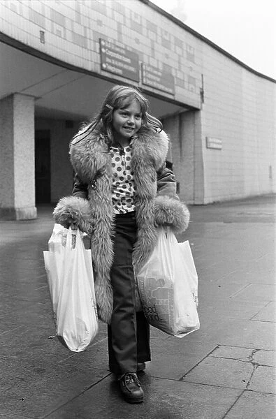 A Young Christmas shopper in Birmingham. 20th December 1975