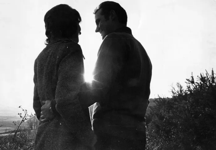 Framed Print : A young couple enjoy a cuddle in the countryside Framed Print : A young couple enjoy a cuddle in the countryside
