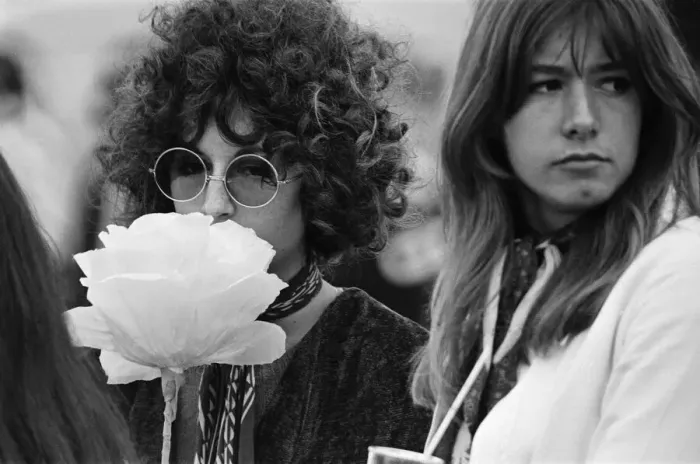Framed Print : A young couple of females, with large flower and fashionable sunglasses at The Windsor