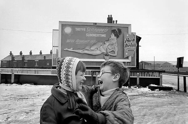 A young couple are highly amused by Nude Billboard Advert. December 1970 71-00003-004