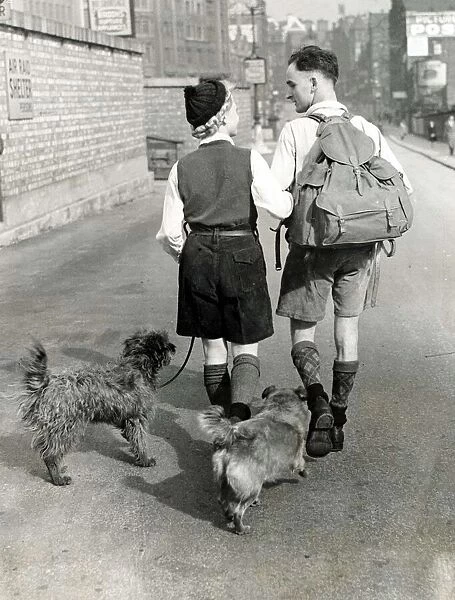 A young couple hiking with their dogs down a Manchester