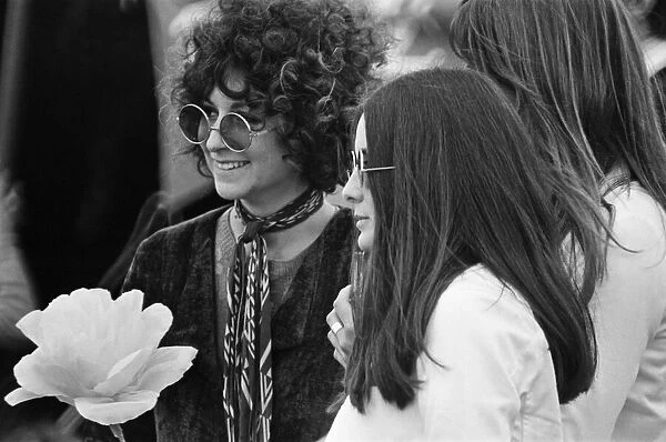 A young couple, with large flower and fashionable sunglasses at The Windsor Jazz Festival