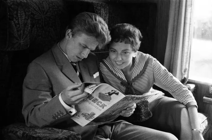 Framed Print : A young couple on a train, reading a copy of Photoplay magazine Framed Print : A young couple on a train, reading a copy of Photoplay magazine