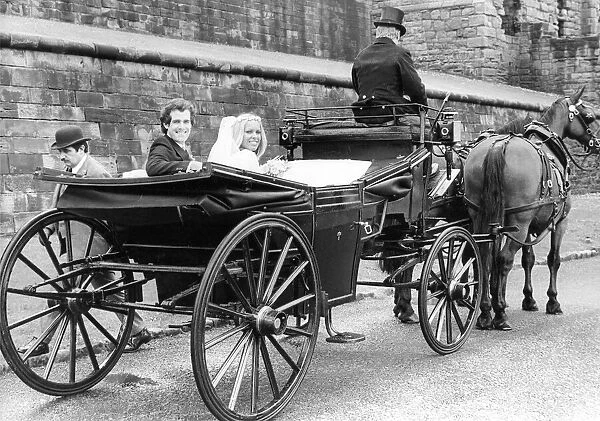 A young couple using a romantic form of transport, a horse and carriage for their wedding
