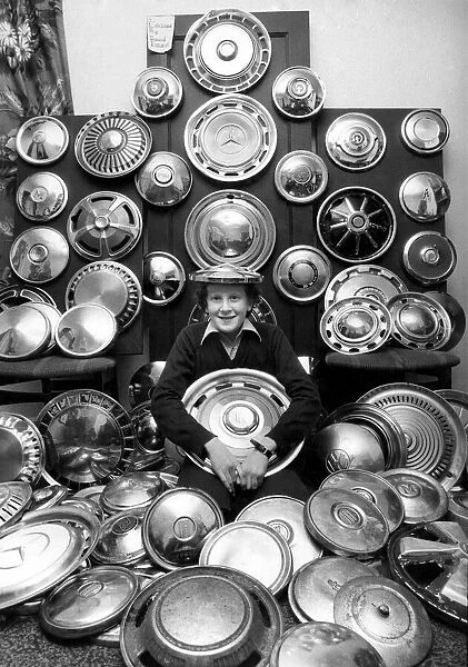 Young David and his collection of 130 caps. He collects hub caps that fly off care near