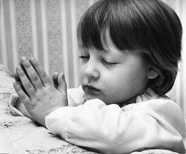 Young Denise Woodhouse praying like a little angel