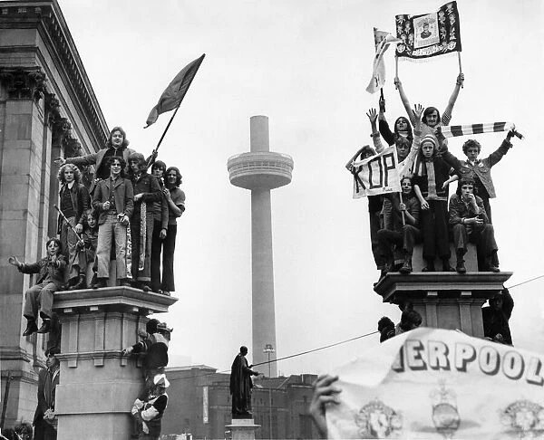 Young fans of Liverpool FC gather in the city centre to welcome their heroes home