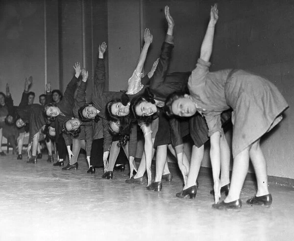 These young female workers in a North West factory are given physical training during