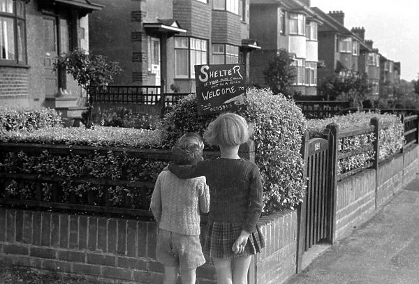 Young girl and boy reading an air raid shelter sign