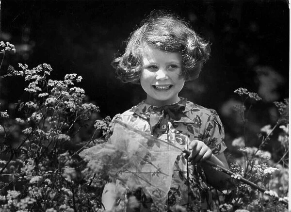Young girl catching butterflies with net. c. 1945 P044491
