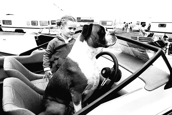 A young girl and her dog try out a speedboat at the Whitley Bay Motor Show. 18  /  07  /  80