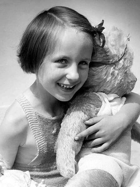 Young girl holding her teddy bear Circa 1945 P044428