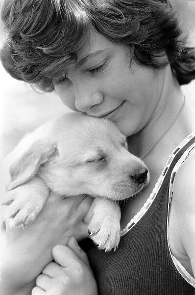 A young girl with a labrador puppy at the Frant Kennels in Hildenborough near Tonbridge