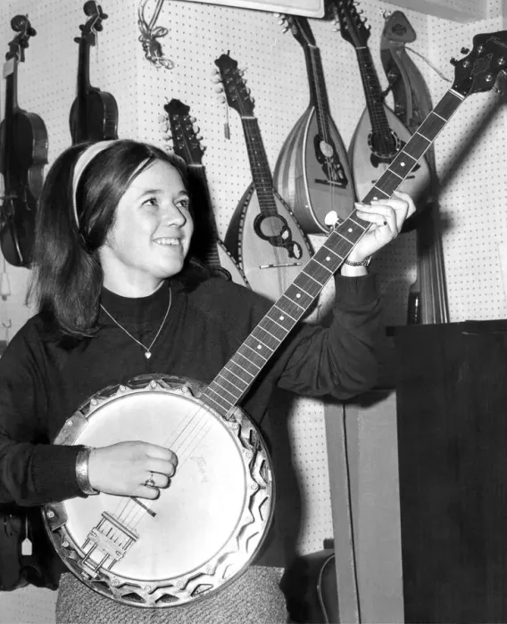 Framed Print : A young girl playing the banjo in September 1968