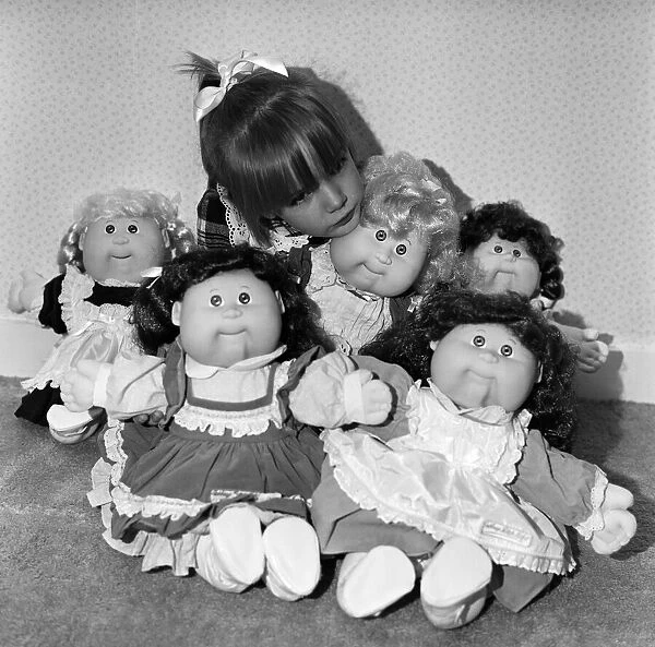 A young girl plays with her Cabbage Patch Dolls. 5th November 1987